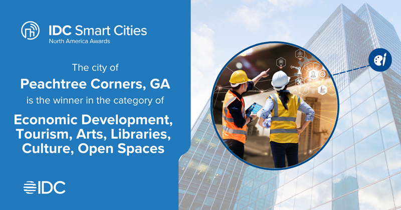 IDC Smart Cities award for economic development with two women in construction clothing.
