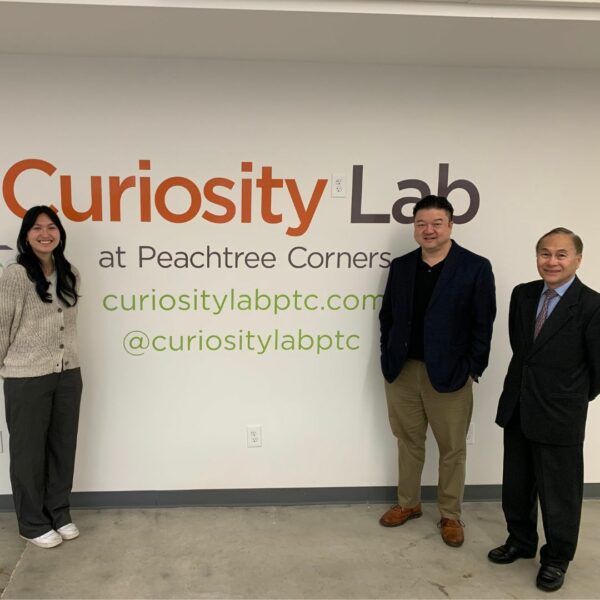 Three people posing at the Innovation Center